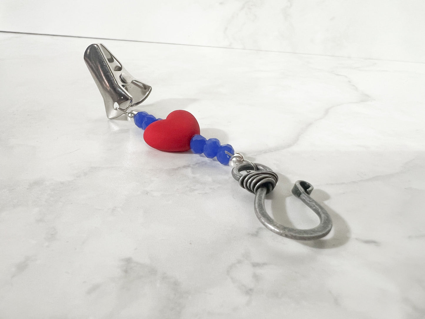red and blue portuguese knitting pin